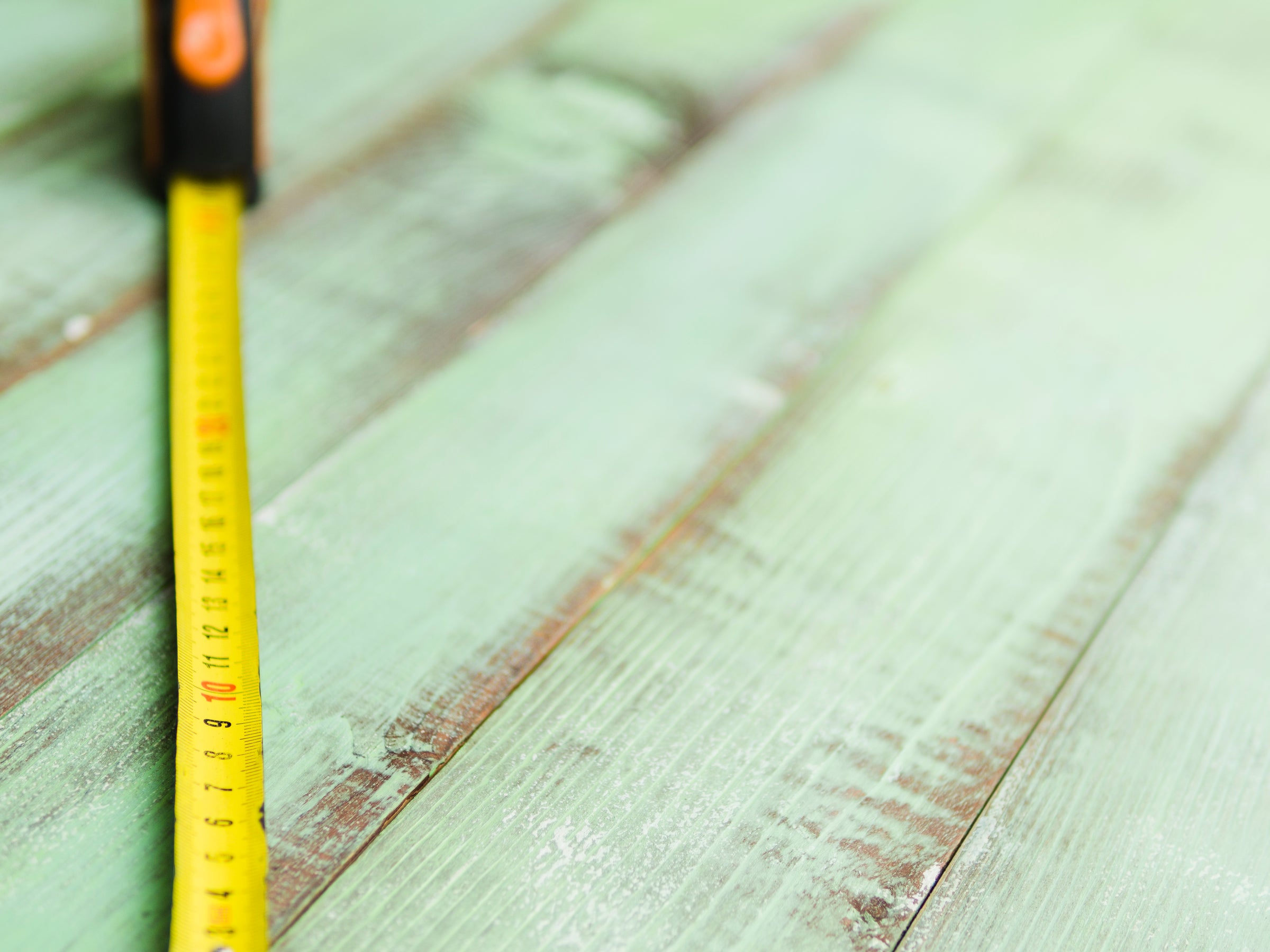 tape measure opened across vintage boards