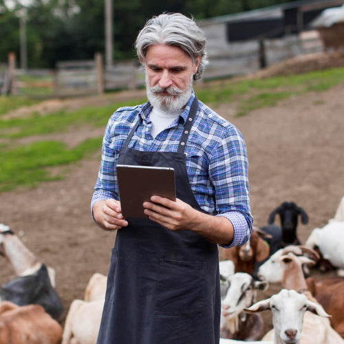 farmer managing wifi connected devices on handheld computer