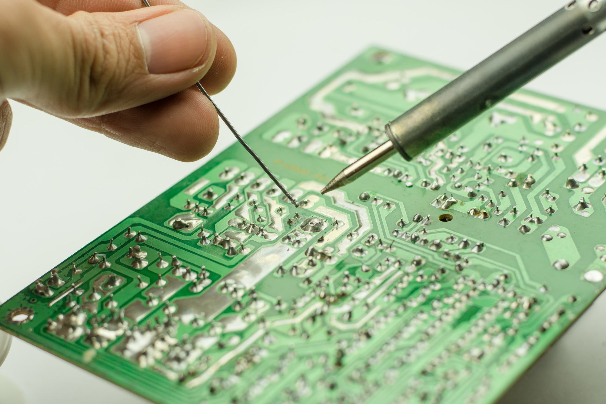 hand soldering on a circuit board